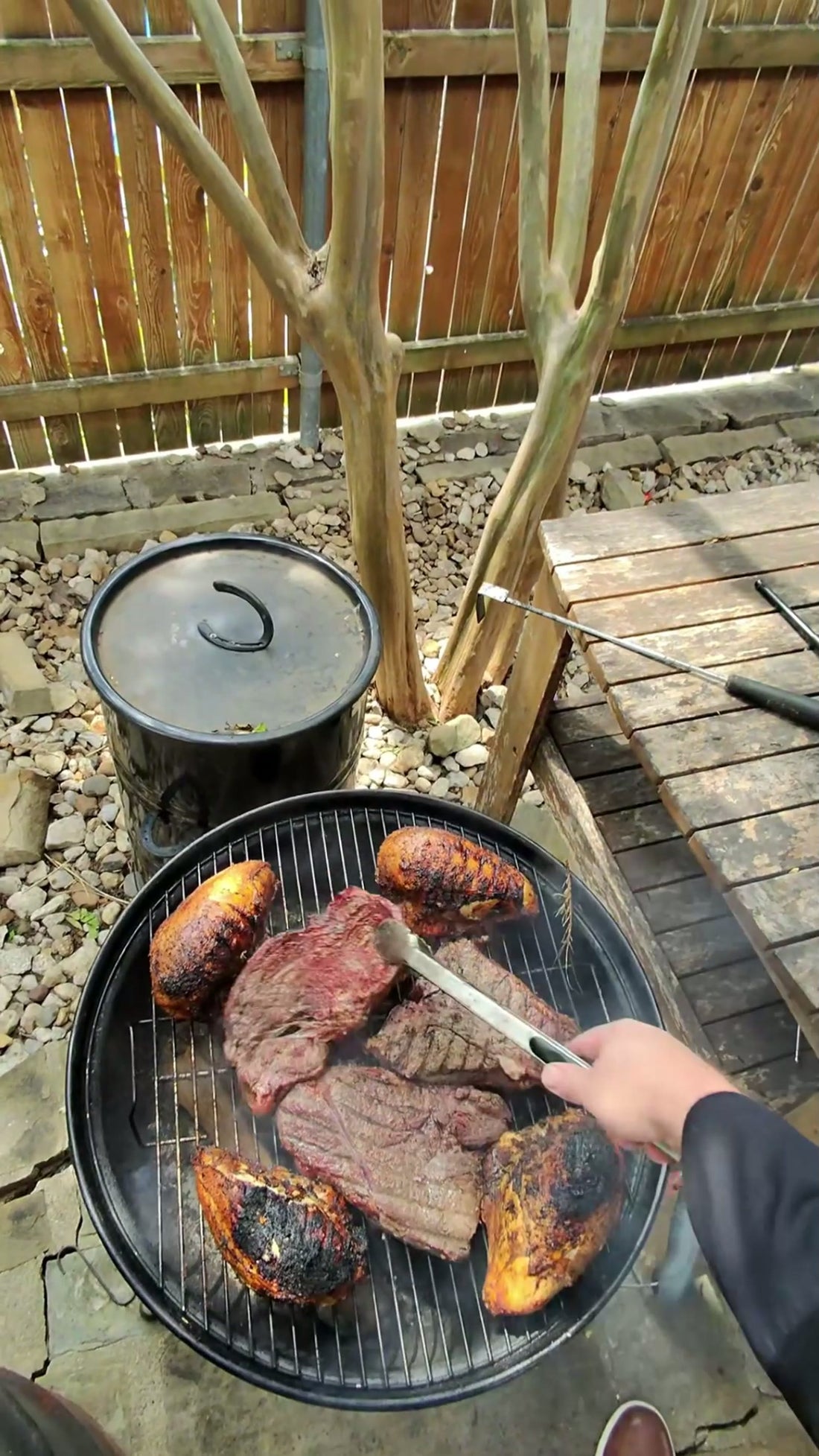 Cubes of caramelized brisket burnt ends over a charcoal grill