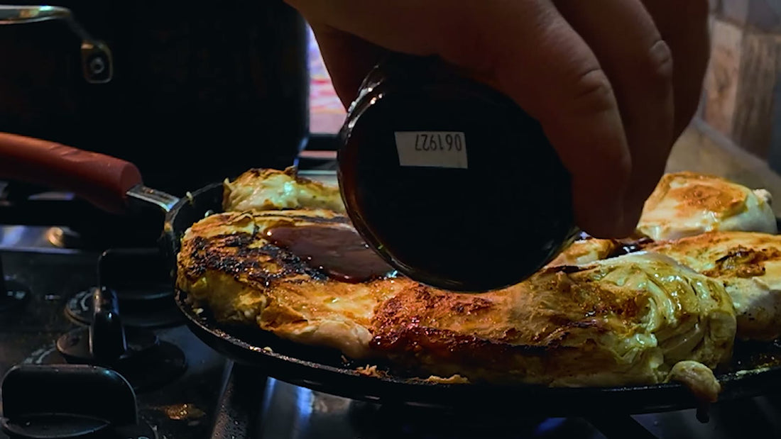 BBQ sauce being poured over meat in a pan