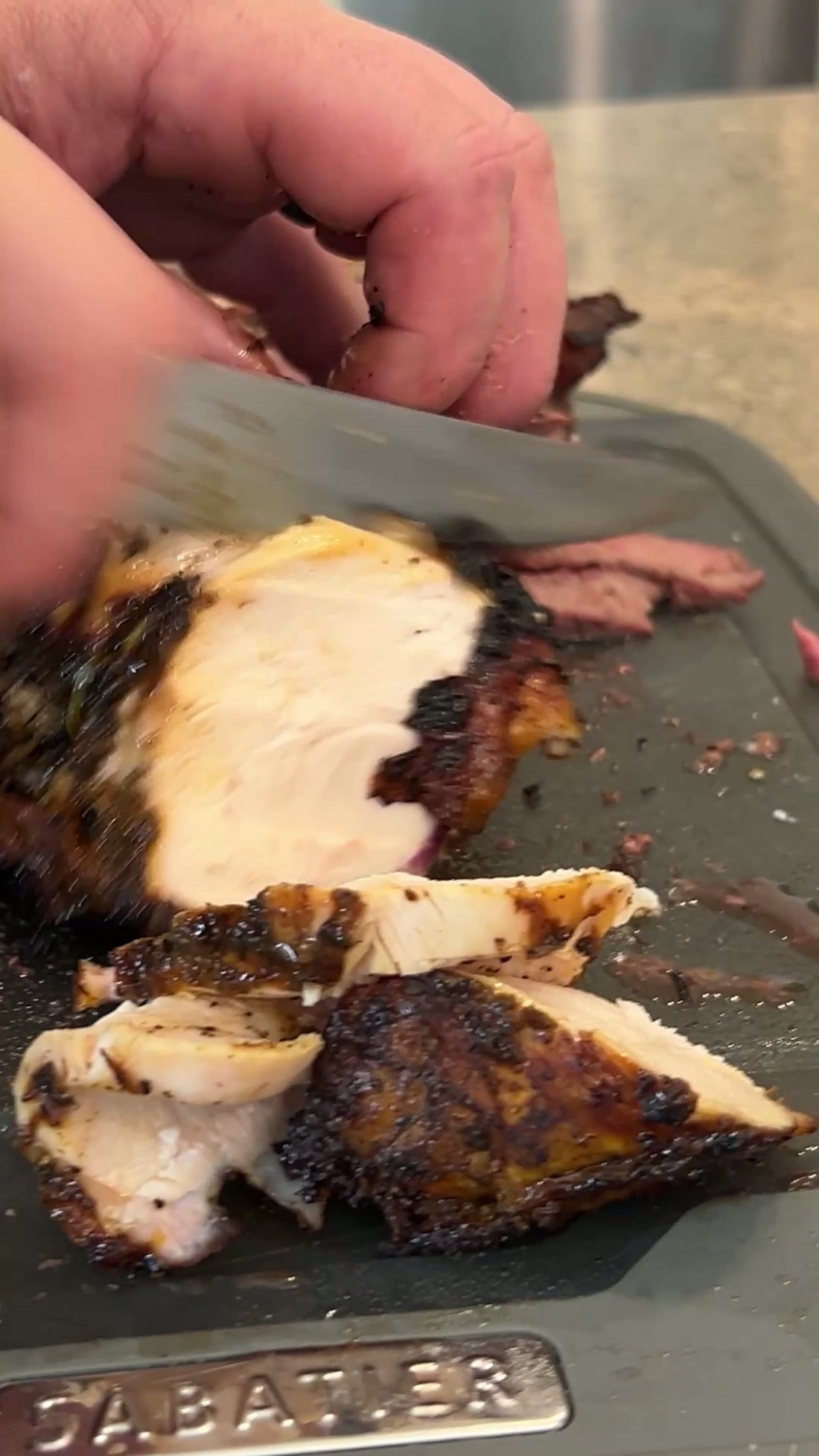 Cooked meat pulled apart on a wooden board