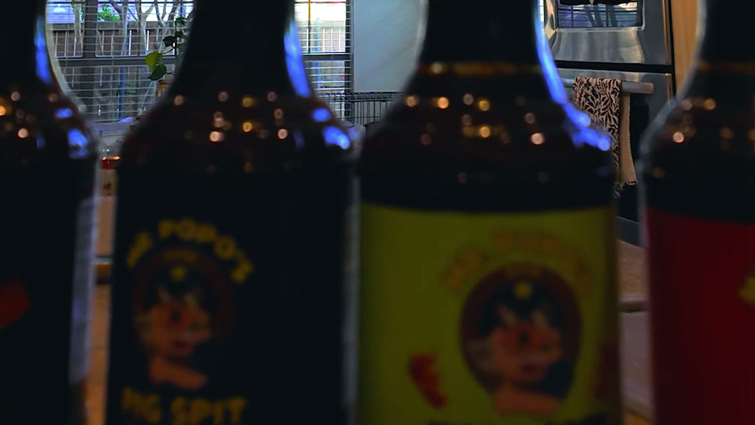 Bottles of Mr. PoPo's Pig Spit BBQ sauce lined up