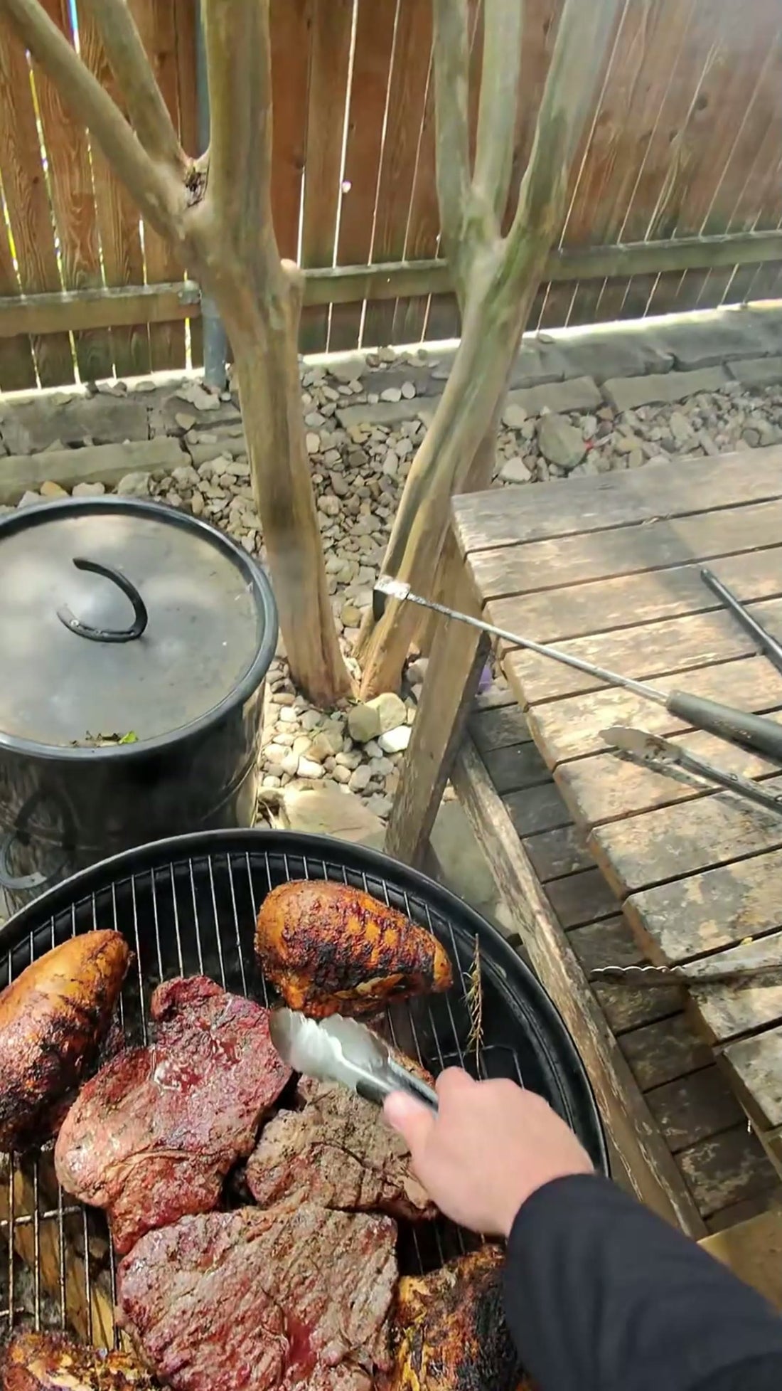 Charred chunks of pork resting on a grill grate